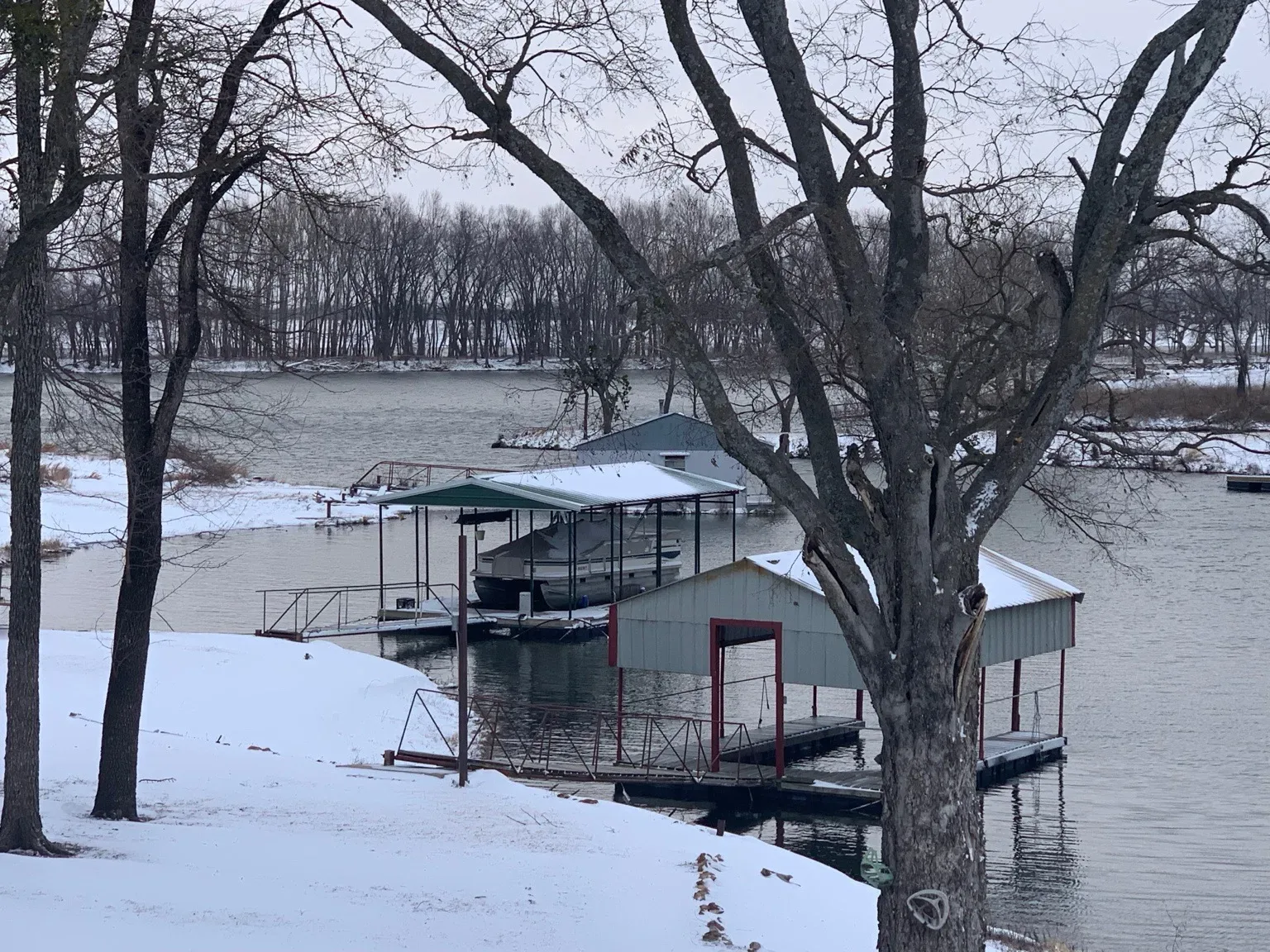 Snow-covered docks and boathouses on Lake Hudson in winter