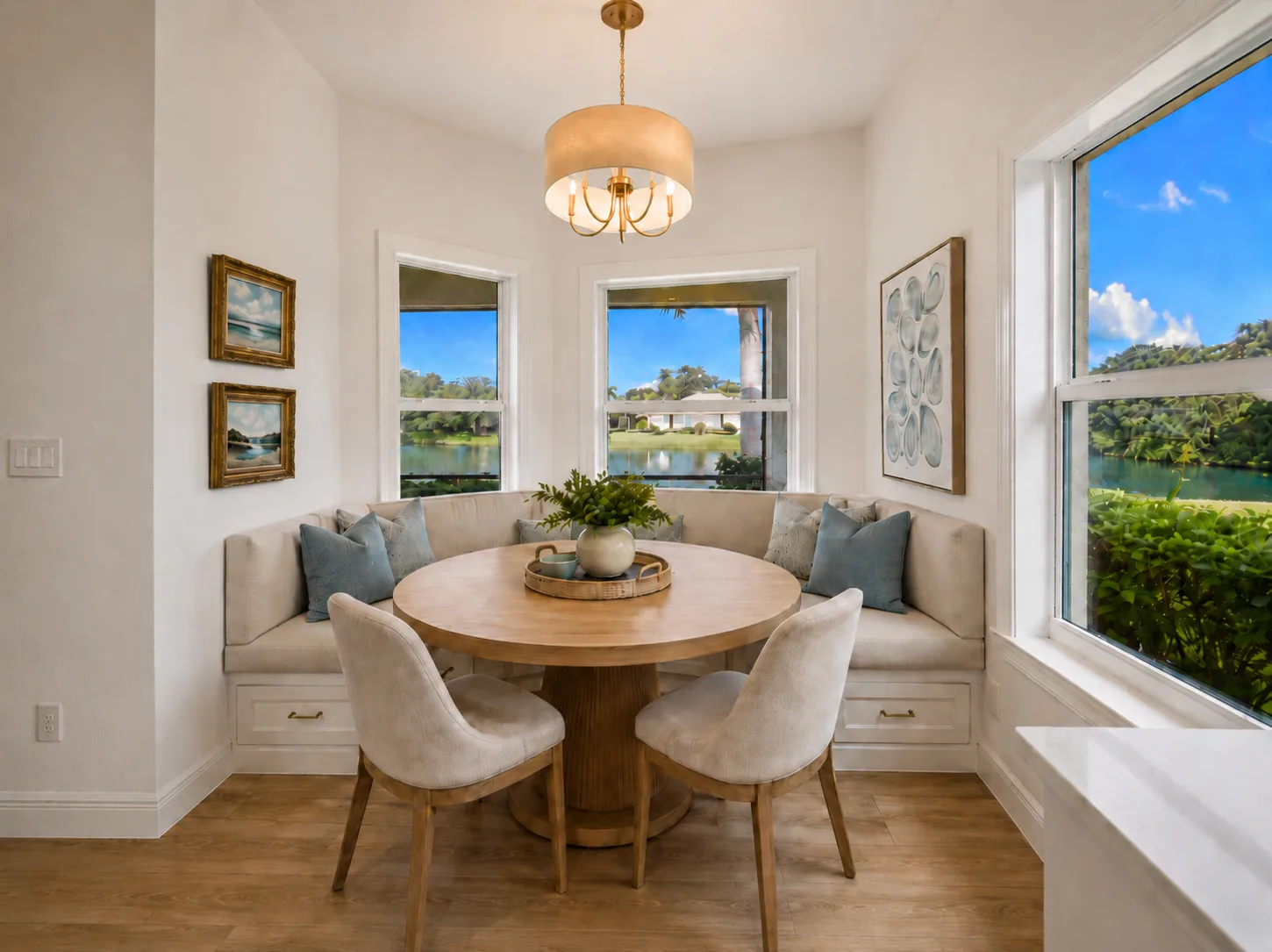 Breakfast Nook : Virtually Staged. Virtually staged to illustrate how the lake-facing breakfast nook could accommodate a round table, banquette-style seating and additional chairs while taking advantage of the surrounding water views.