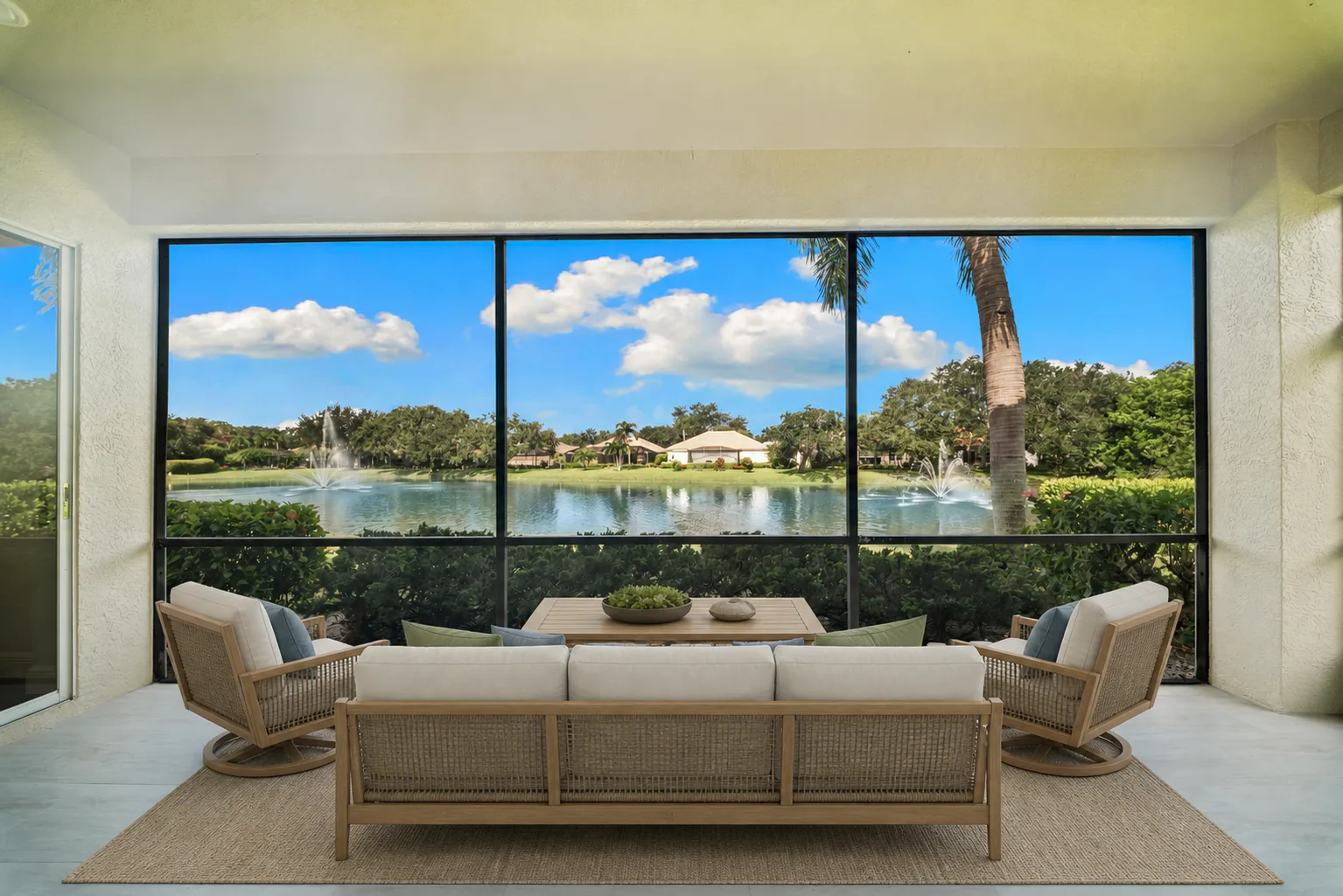 Screened Lanai : Virtually Staged. Virtually staged to illustrate the potential of the screened outdoor living area as an extension of the main living space overlooking the lake.
