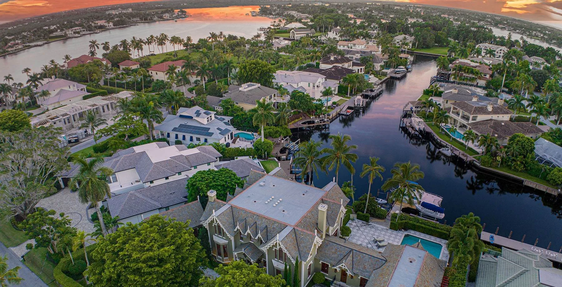 Panoramic aerial view of Aqualane Shores waterfront canals at golden hour