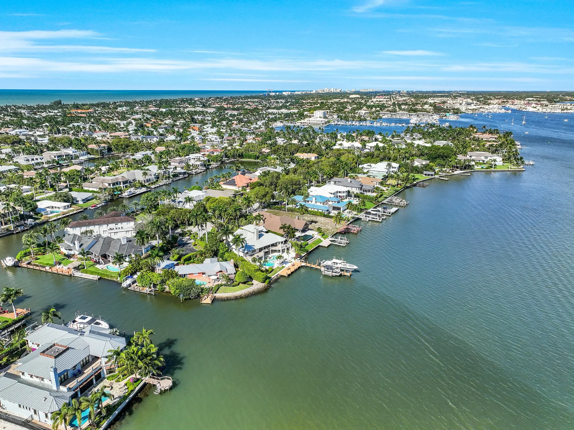 High-altitude aerial of Aqualane Shores waterfront neighborhood with canals and boats