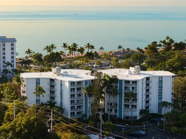 Aerial view of coastal condominium complex in Coquina Sands with white buildings and beachfront setting