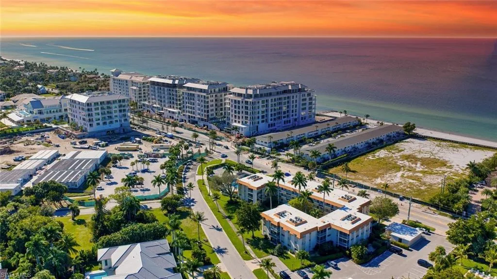 Aerial view of Coquina Sands coastal buildings and beach at sunset