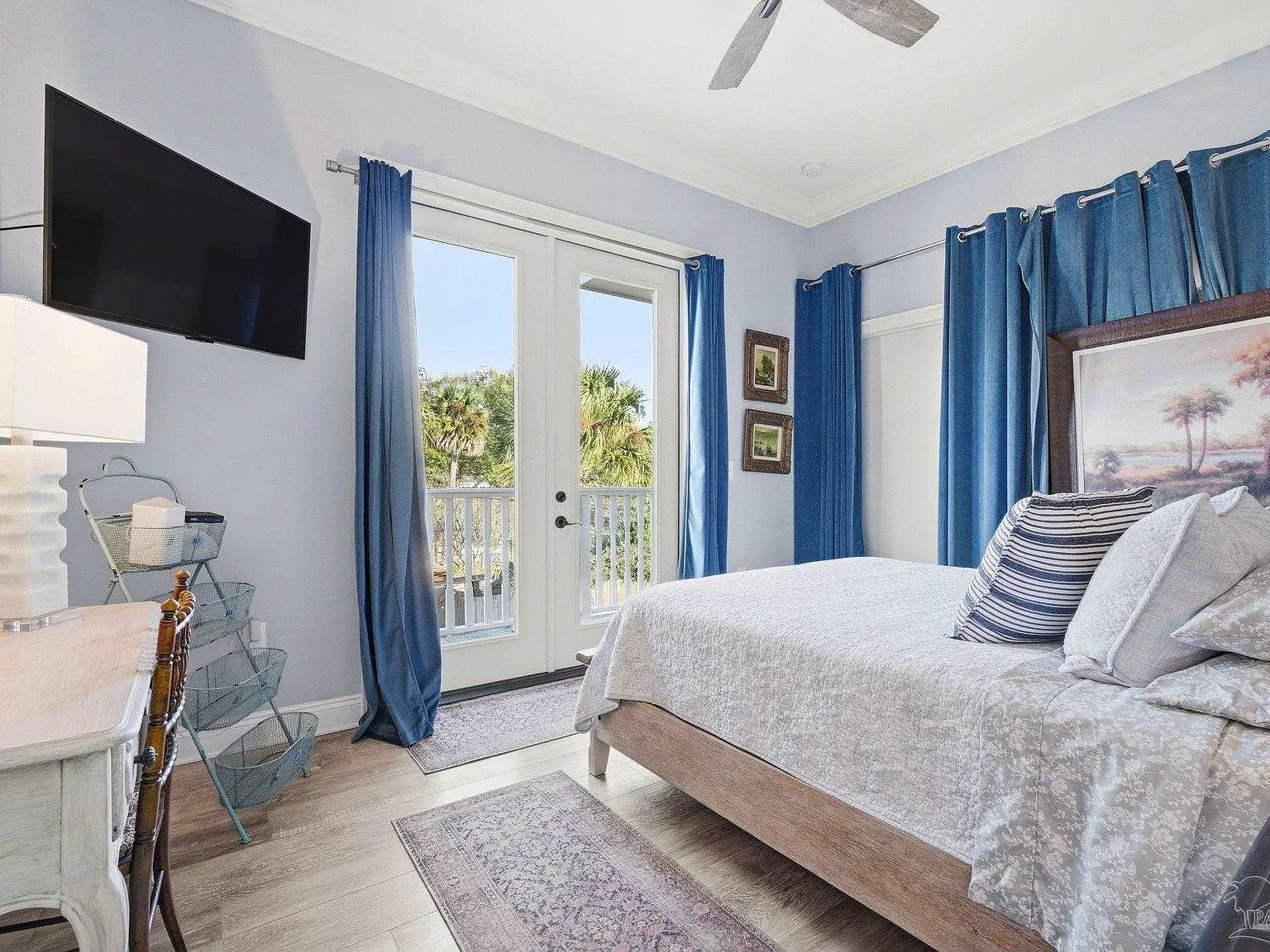 A light blue Queen Anne bedroom suite with French doors opening to a balcony.