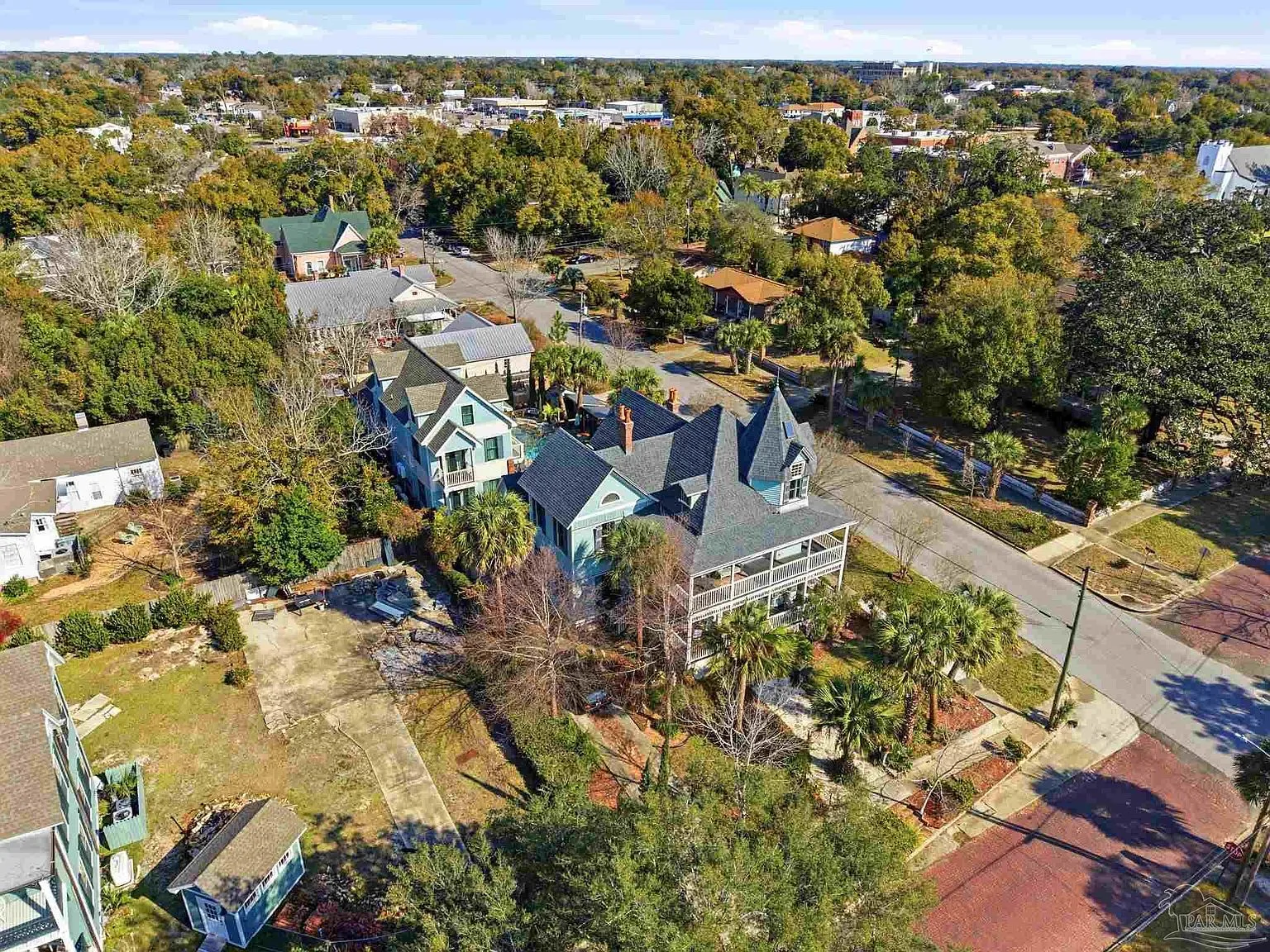 Daytime drone view of the full property lot, pool courtyard, and surrounding Old East Hill homes.