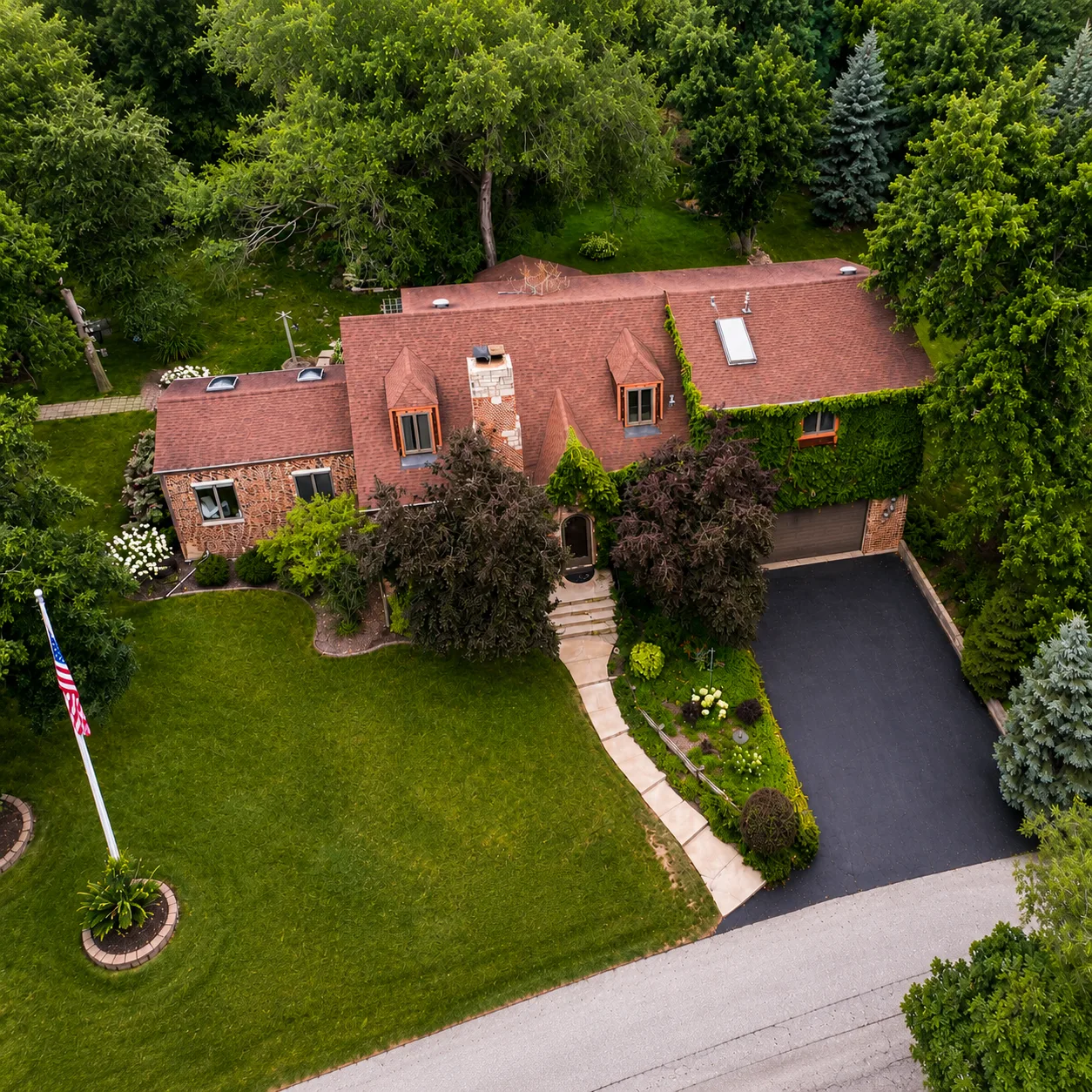 Full aerial view of 3708 Cooper Place on its wooded lot