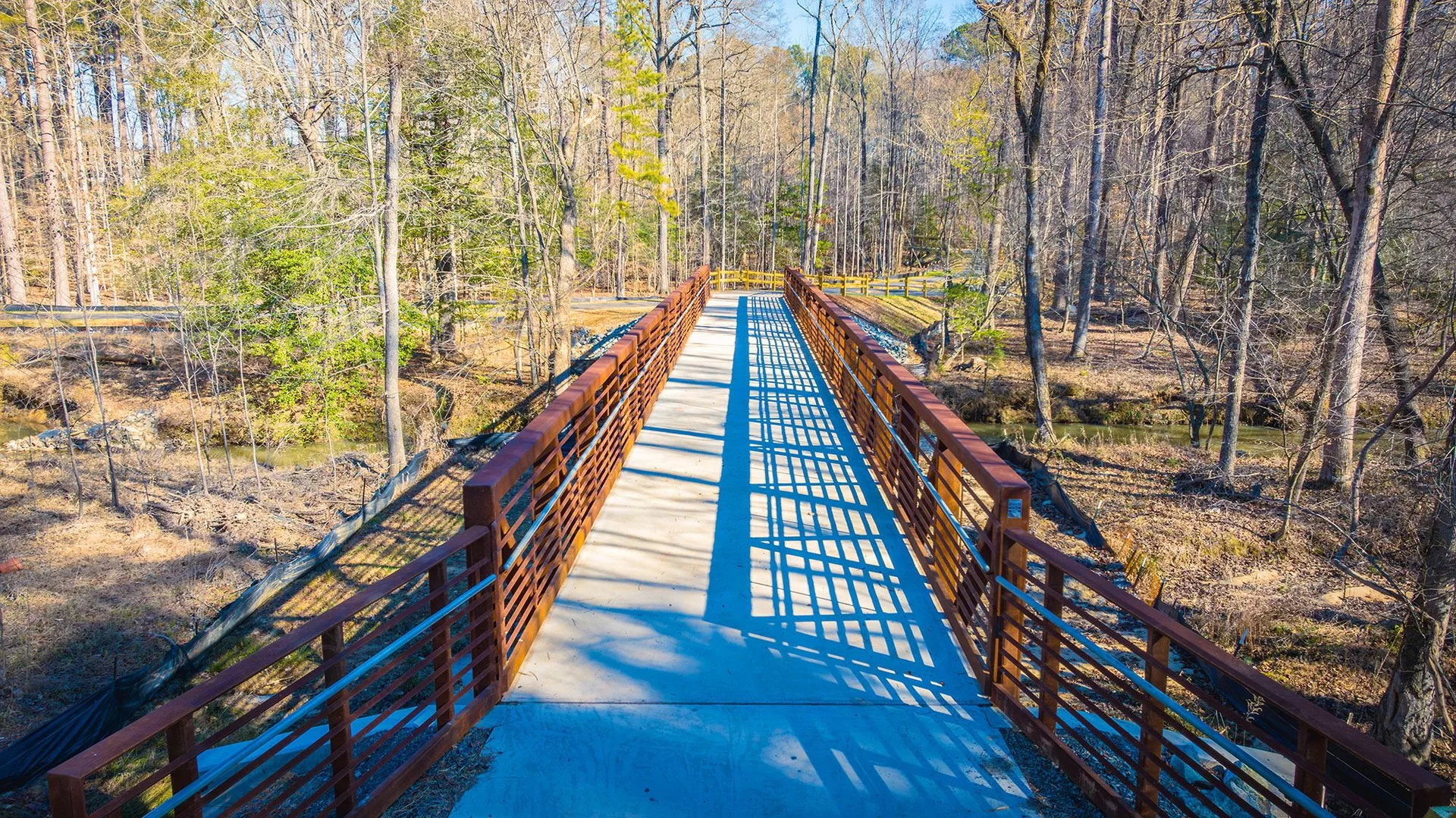 Pedestrian bridge over a stream along the American Tobacco Trail near The Hills at Southpoint