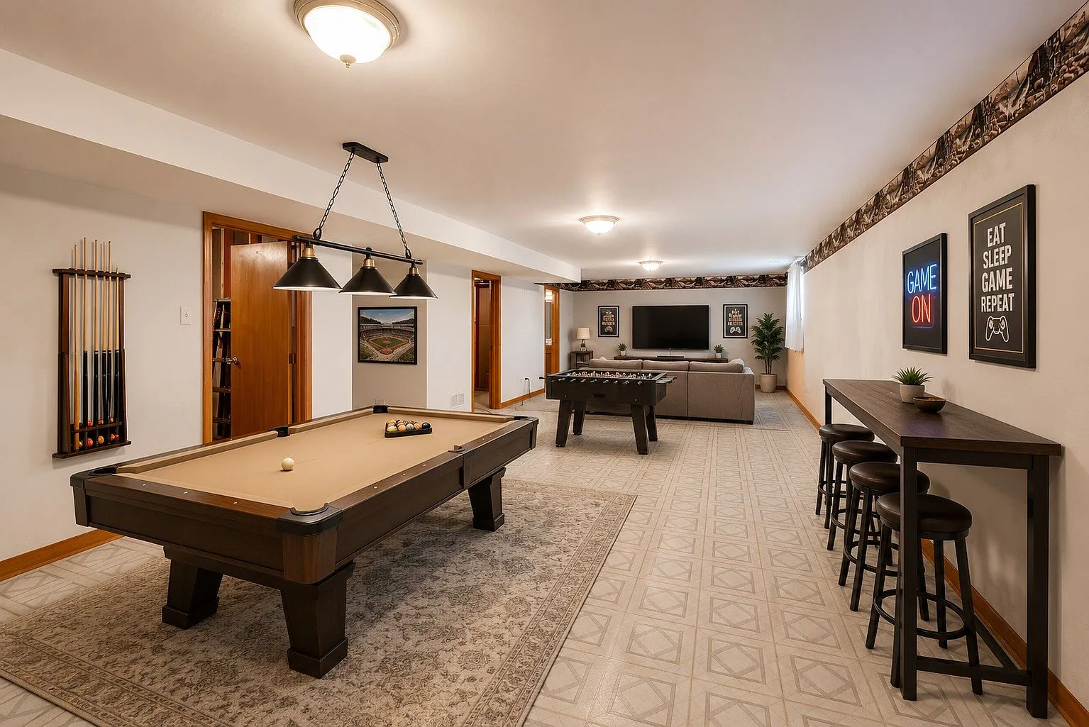 Finished basement recreation room with pool table and bar seating