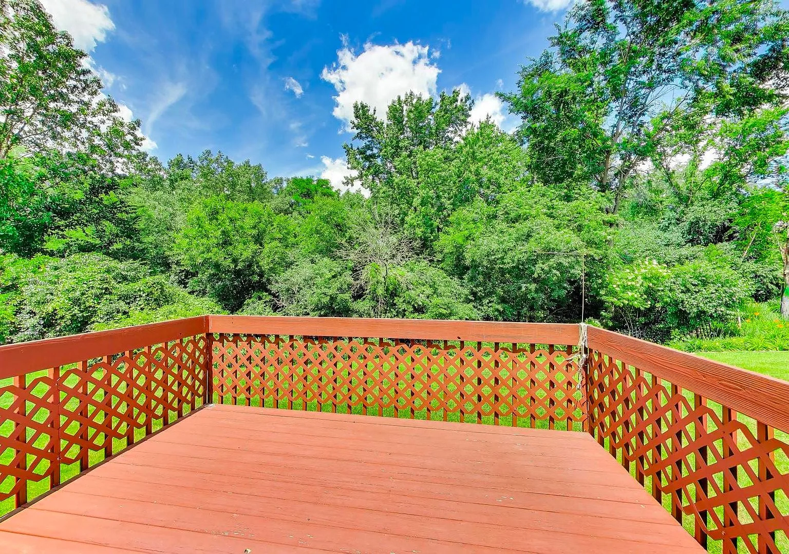 Private wooden deck overlooking mature trees at 231 Hillcrest Lane