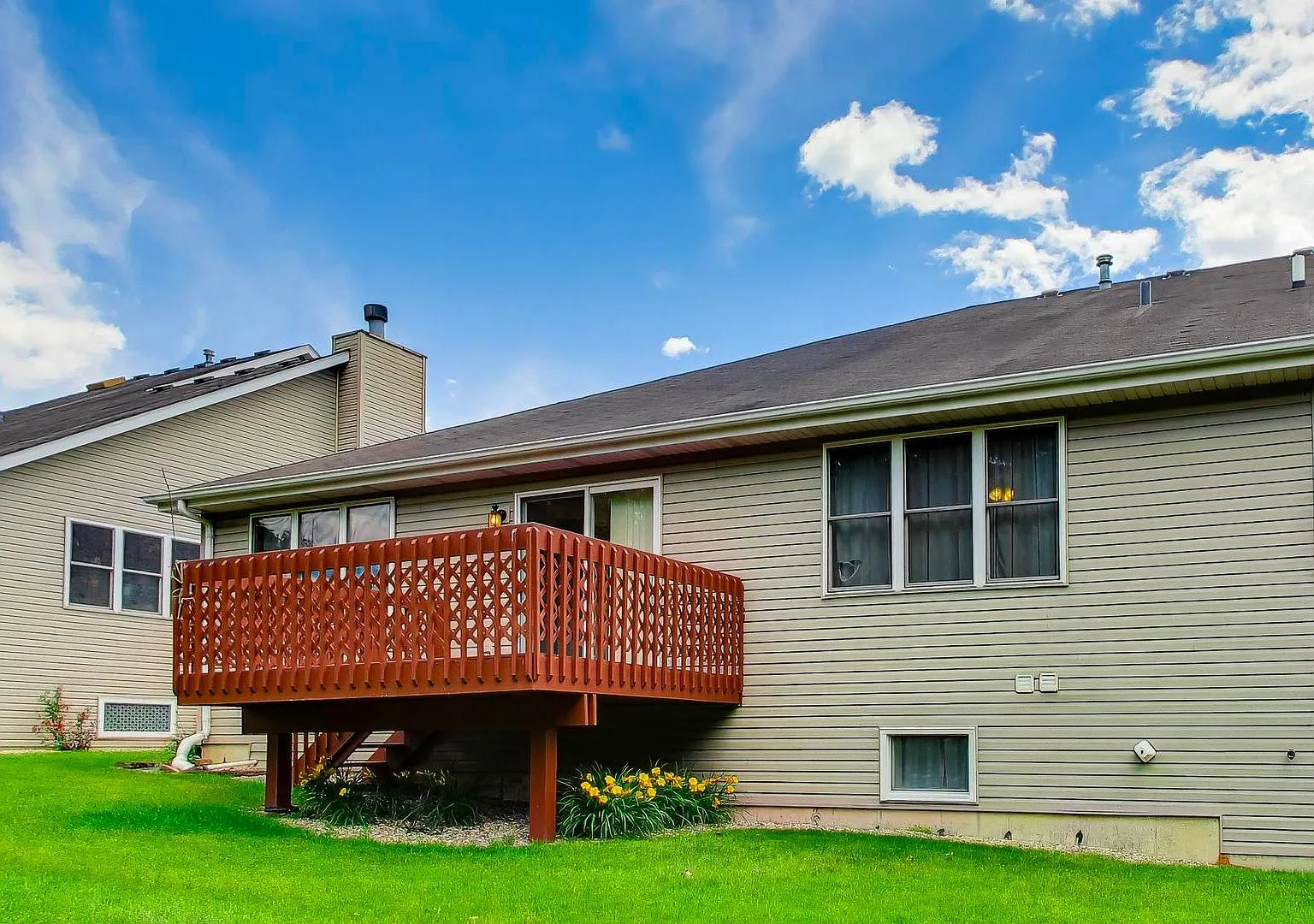 Raised wooden deck attached to the townhome
