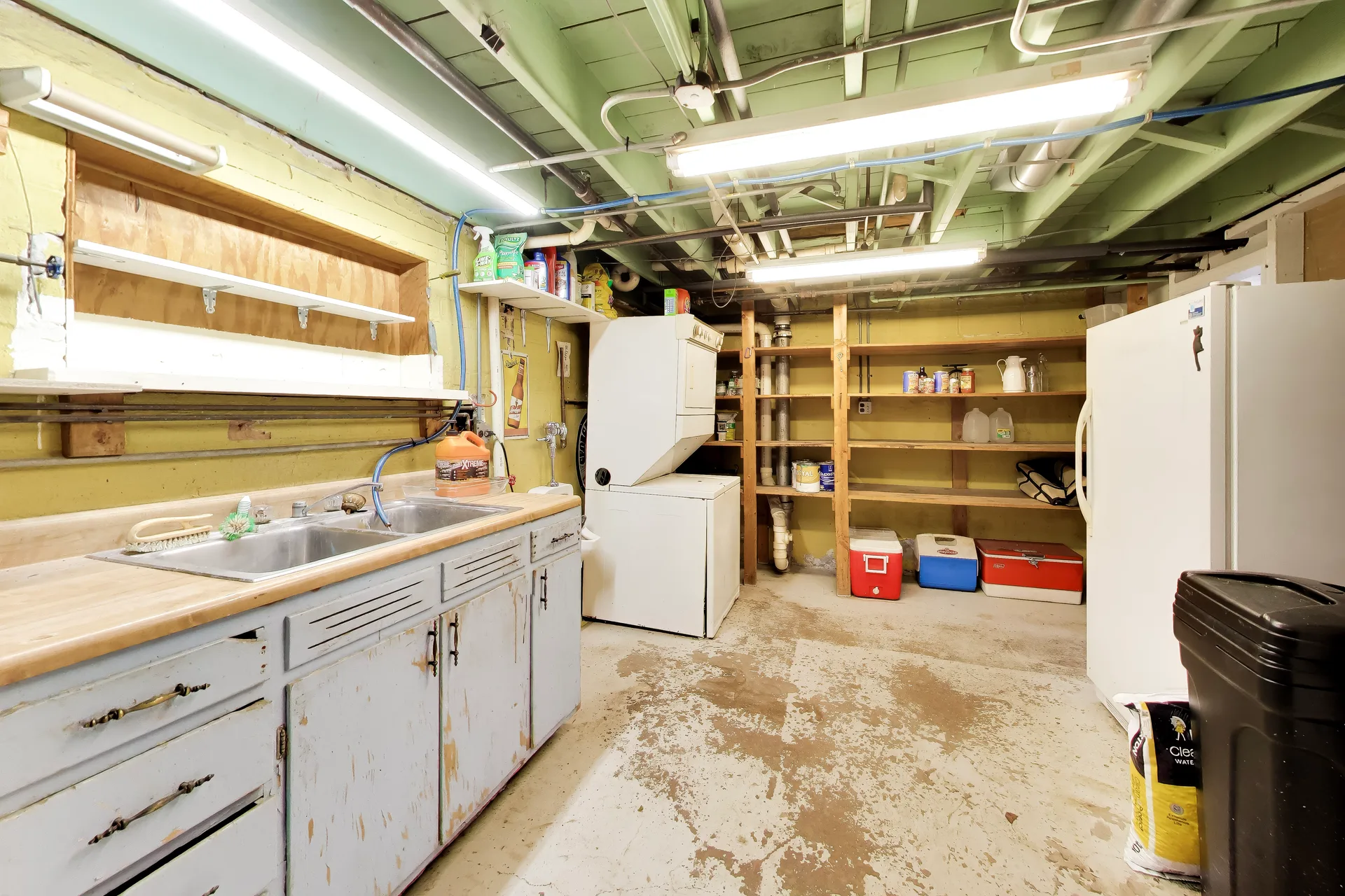 Basement utility space with cabinetry and sink