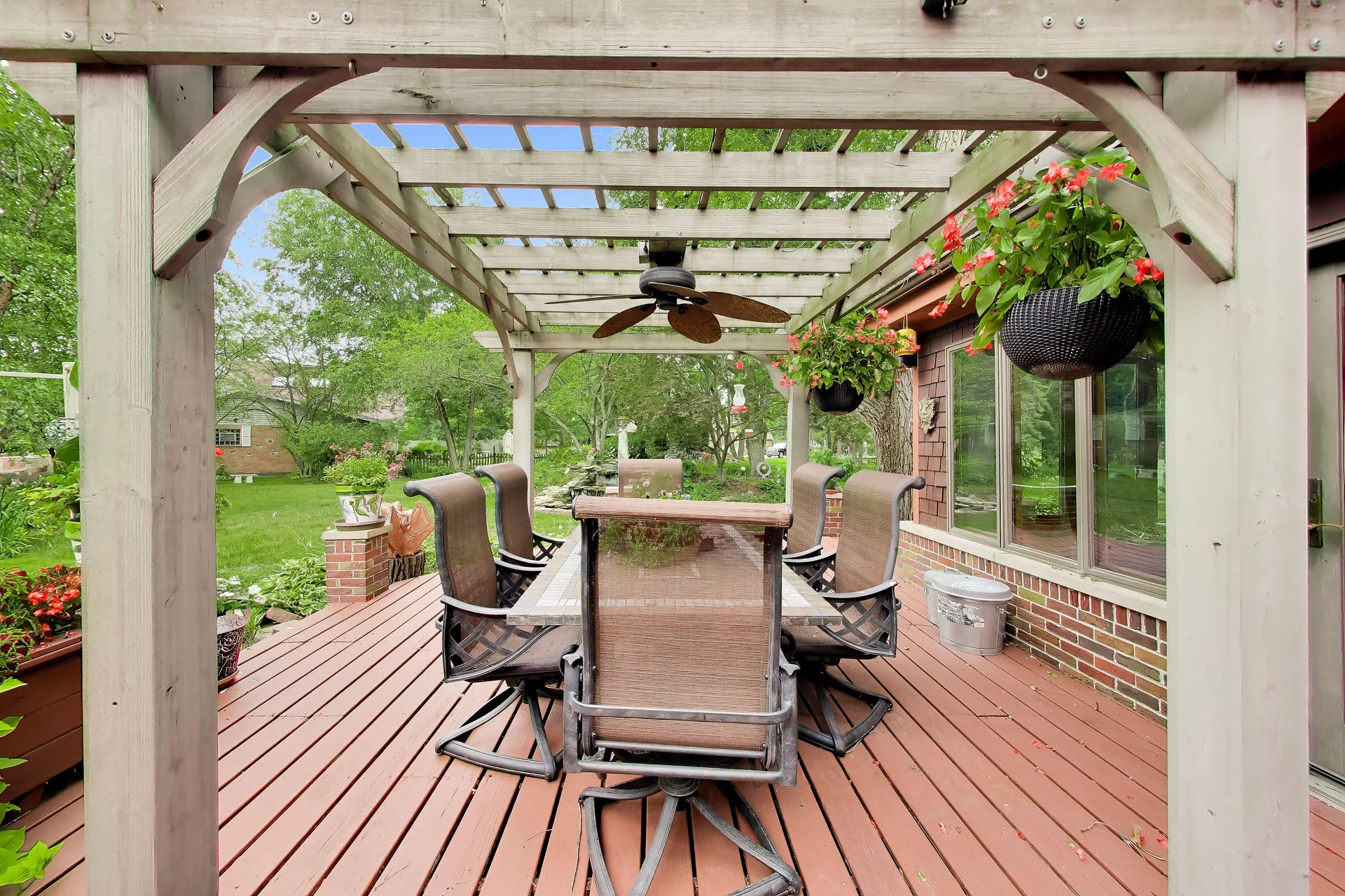 Covered pergola deck with seating and ceiling fan