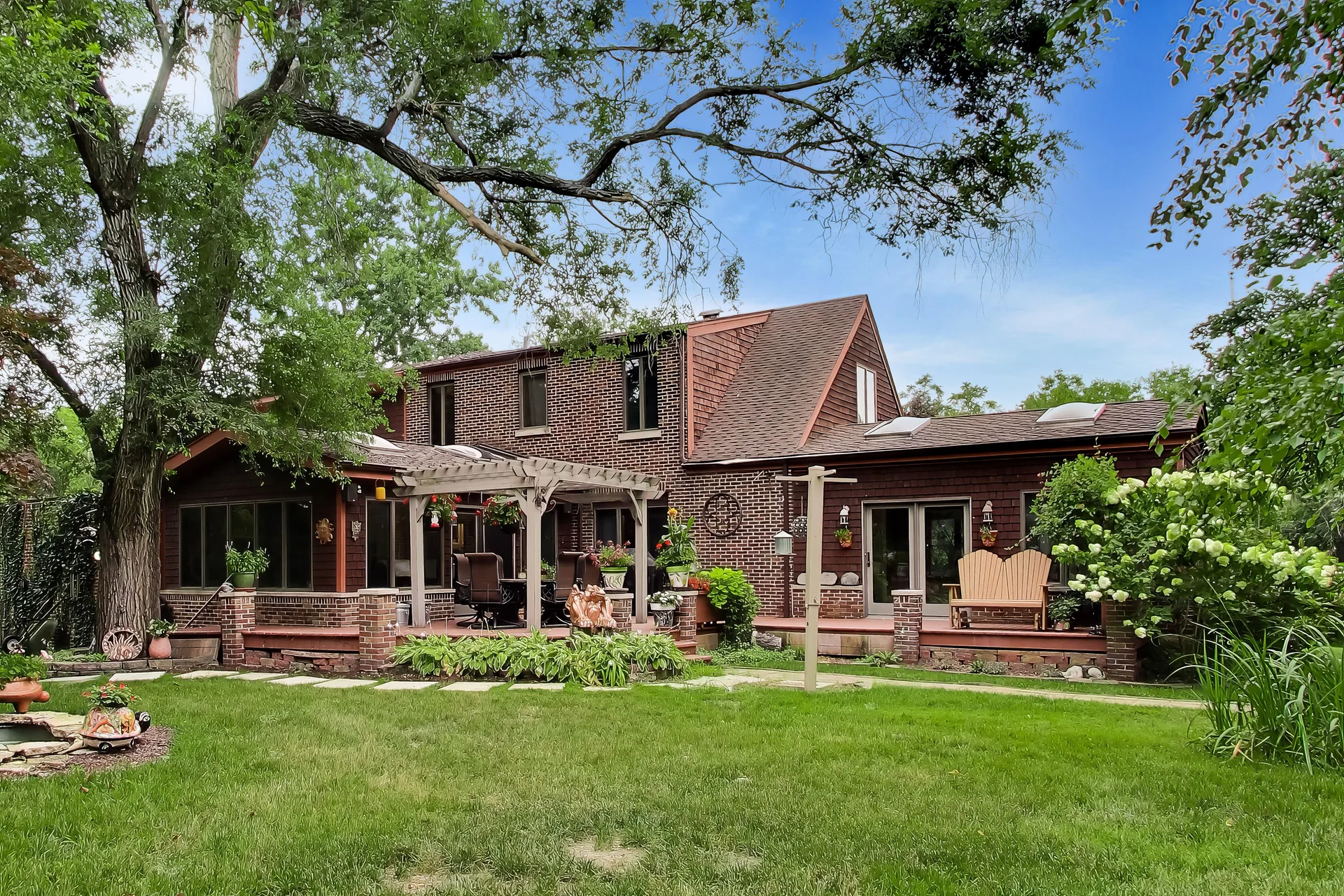Wooden deck with pergola on the two-story residence