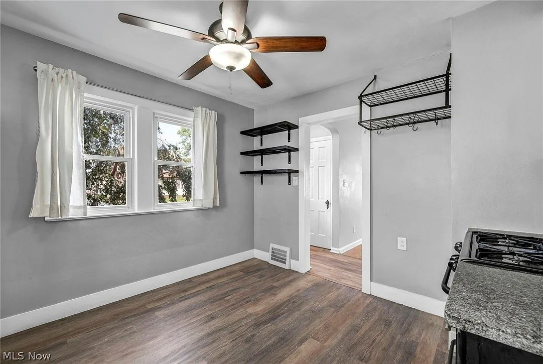 Kitchen and dining area with wood-look flooring and white trim