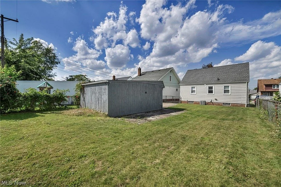 Detached garage and backyard lawn behind the bungalow