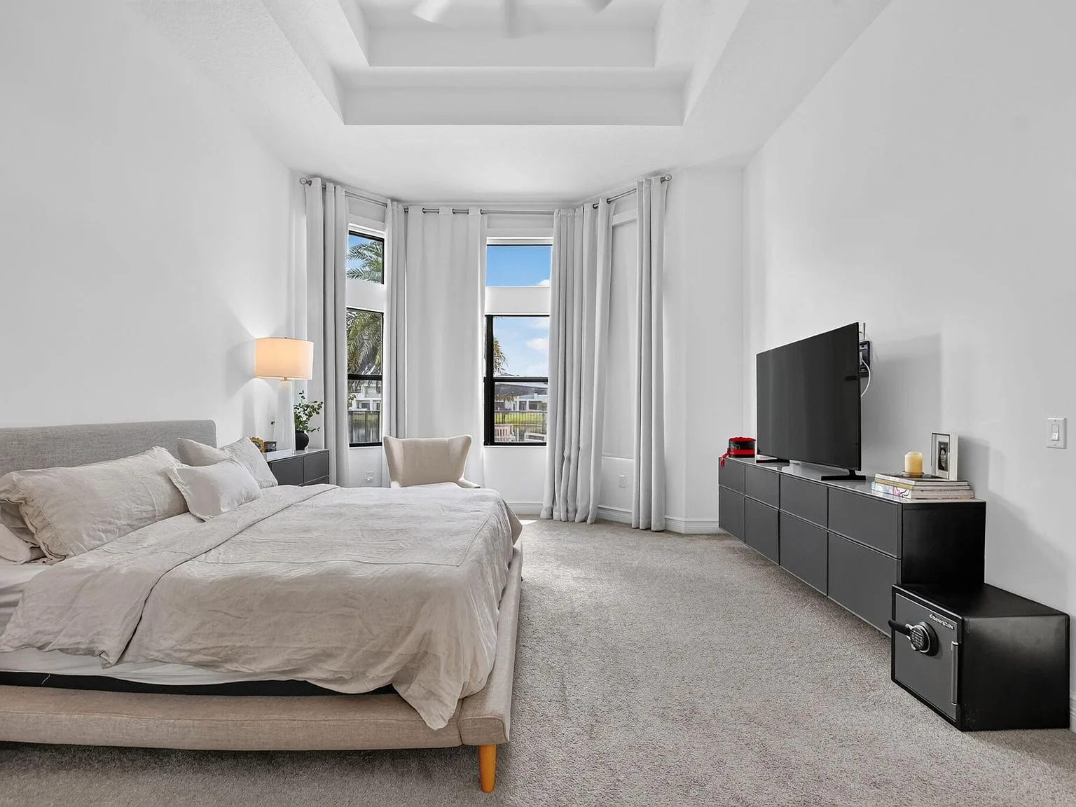 The primary bedroom at 16740 Strasbourg Lane bathed in daylight from a bay window
