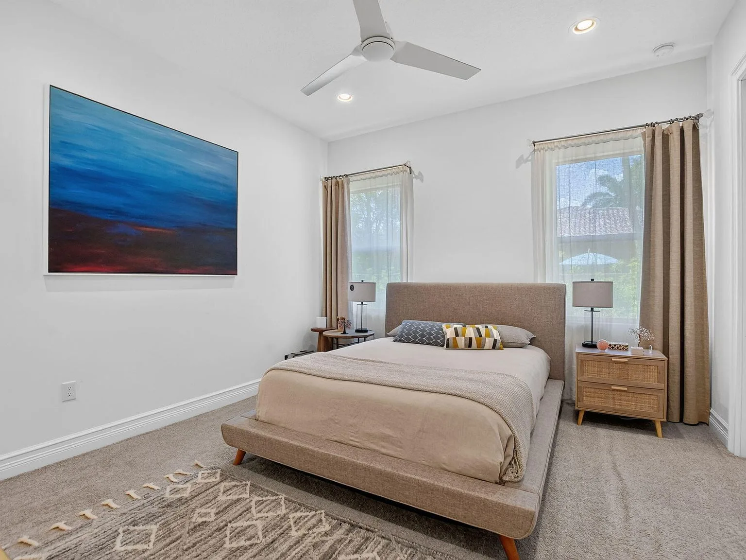 A guest bedroom at 16740 Strasbourg Lane with a volume ceiling and soft neutral tones