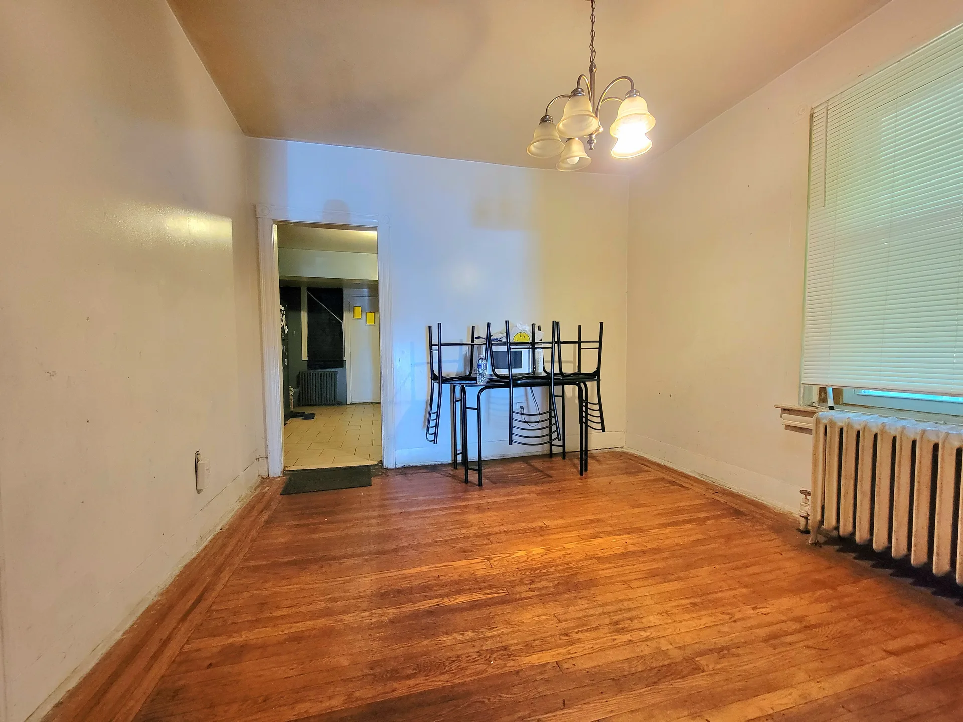 Dining room with hardwood floors and a chandelier in a traditional Philadelphia home