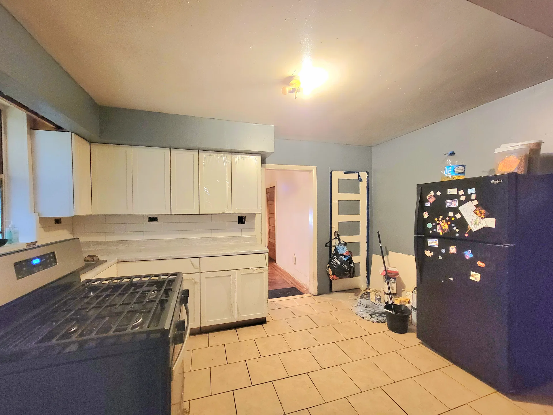 A bright kitchen with white cabinets and tile flooring in a Philadelphia home