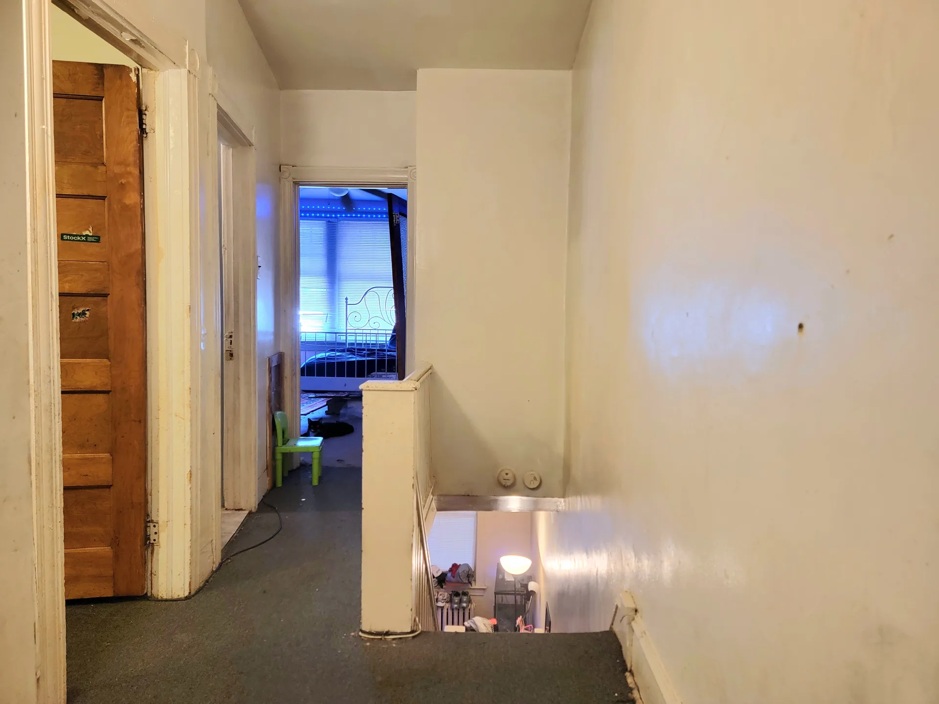 Interior hallway and stairwell with white walls and wood trim in a traditional Philadelphia home