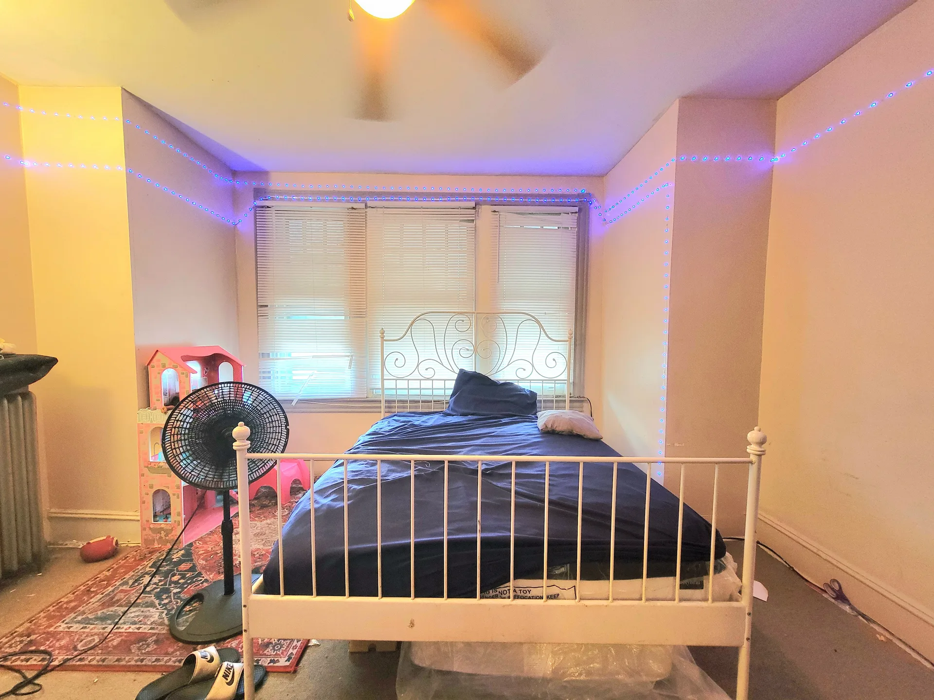 Bedroom interior with a white metal bed frame in a Philadelphia-area home
