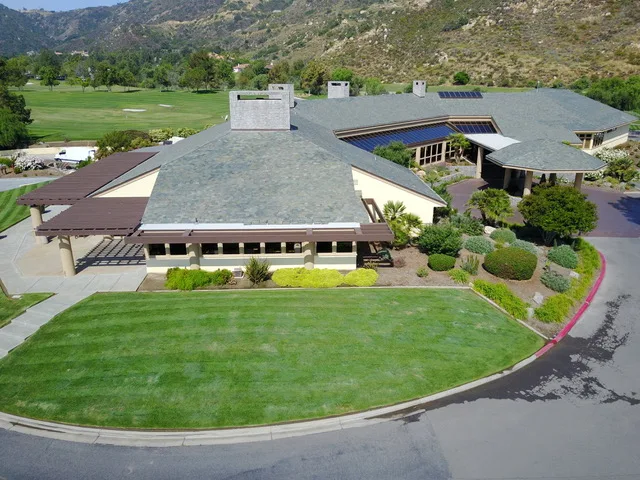 Aerial view of the Bear Creek clubhouse with the golf course behind it in Murrieta California