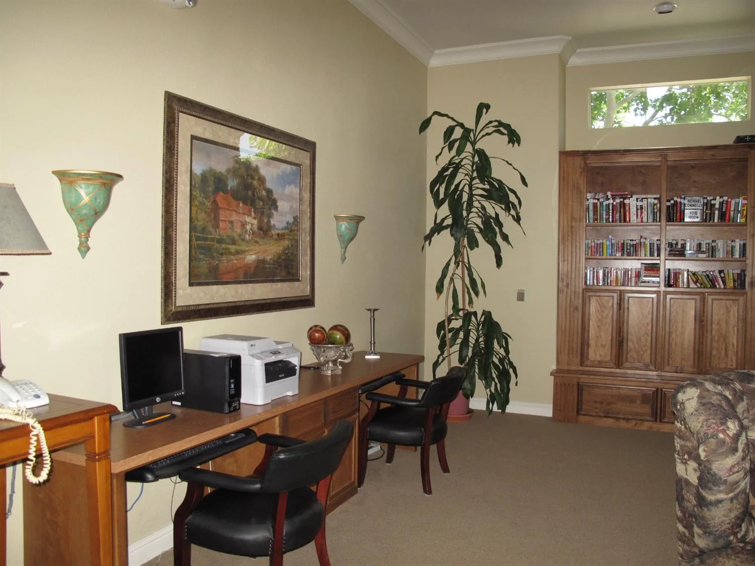 A home office and study full of bookshelves and belongings being sorted