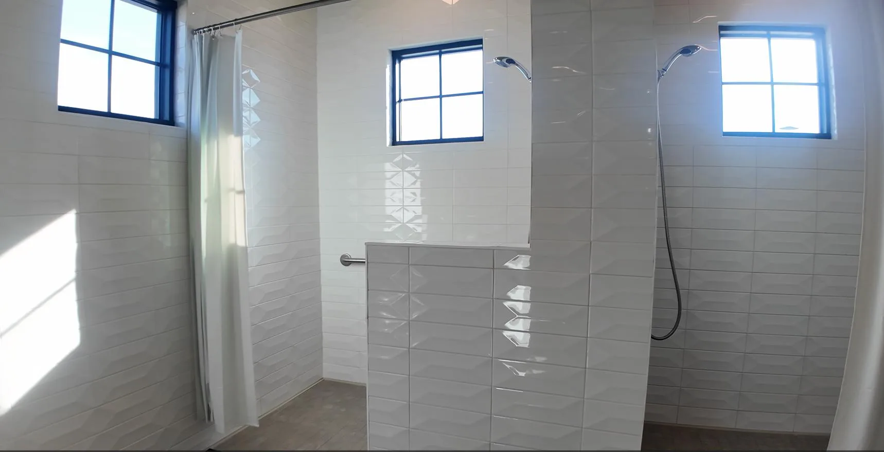 A contemporary bathroom with a walk-in tiled shower and clean, accessible lines in a Northern California 55+ home