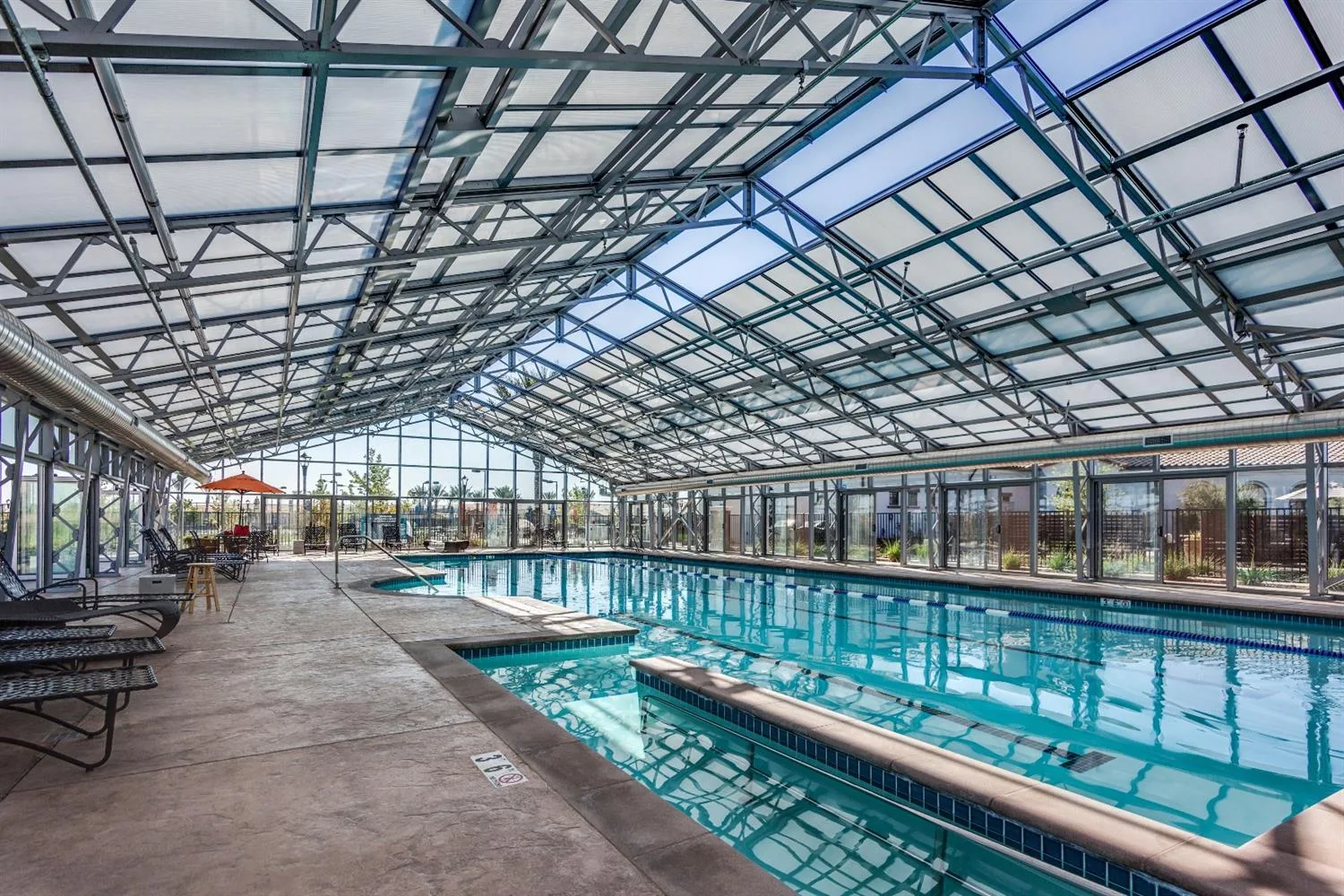 Indoor swimming pool under a glass atrium at the Heritage El Dorado Hills clubhouse in El Dorado Hills, California