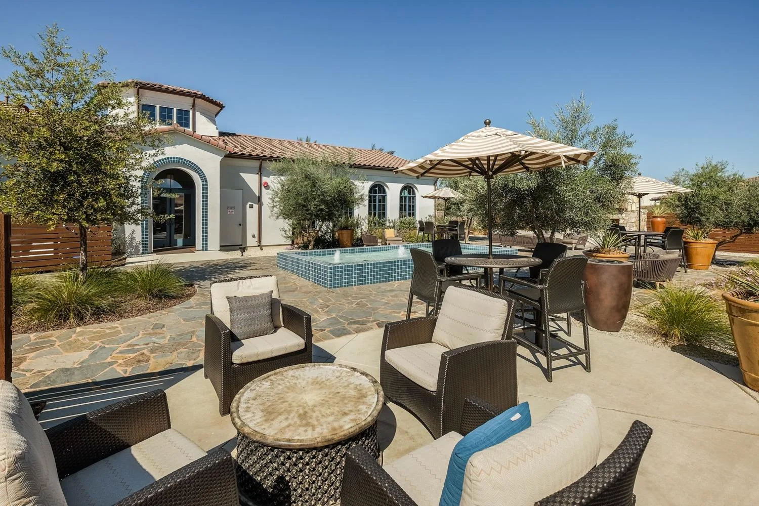 A backyard patio with a fountain at a home in Heritage El Dorado Hills, El Dorado Hills, California