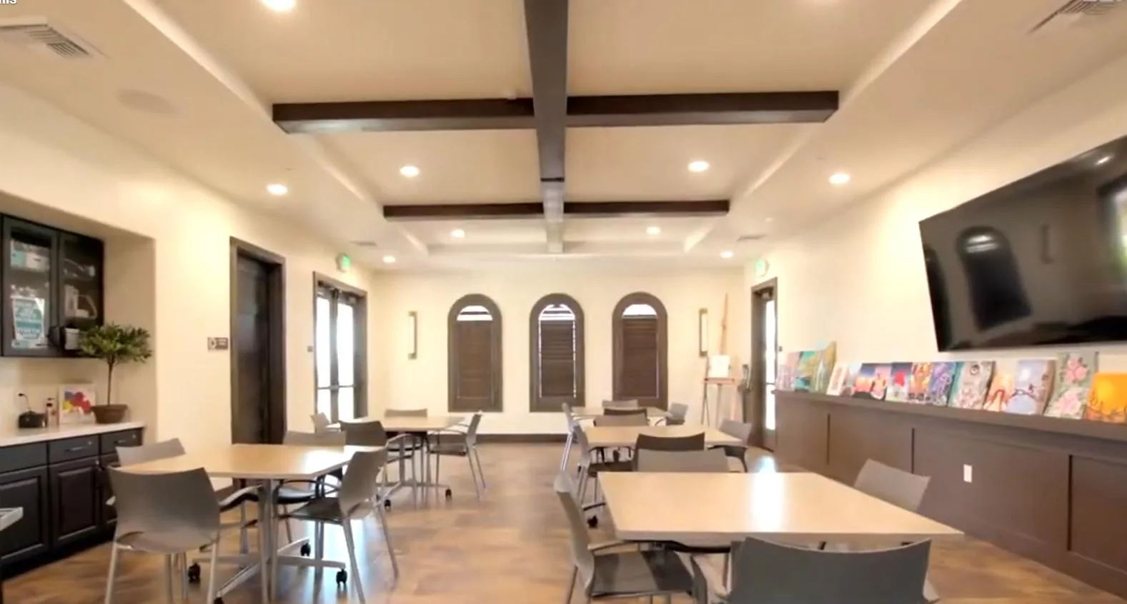 A large multipurpose community room with tables and chairs ready for a banquet or family event