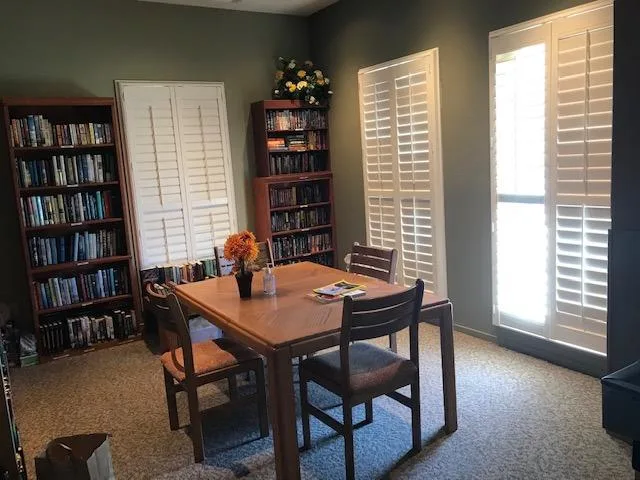 A family home office with bookcases and a desk where legal and financial records would be gathered before a sale. Photo: NorCal55Plus (home-office-library.webp).