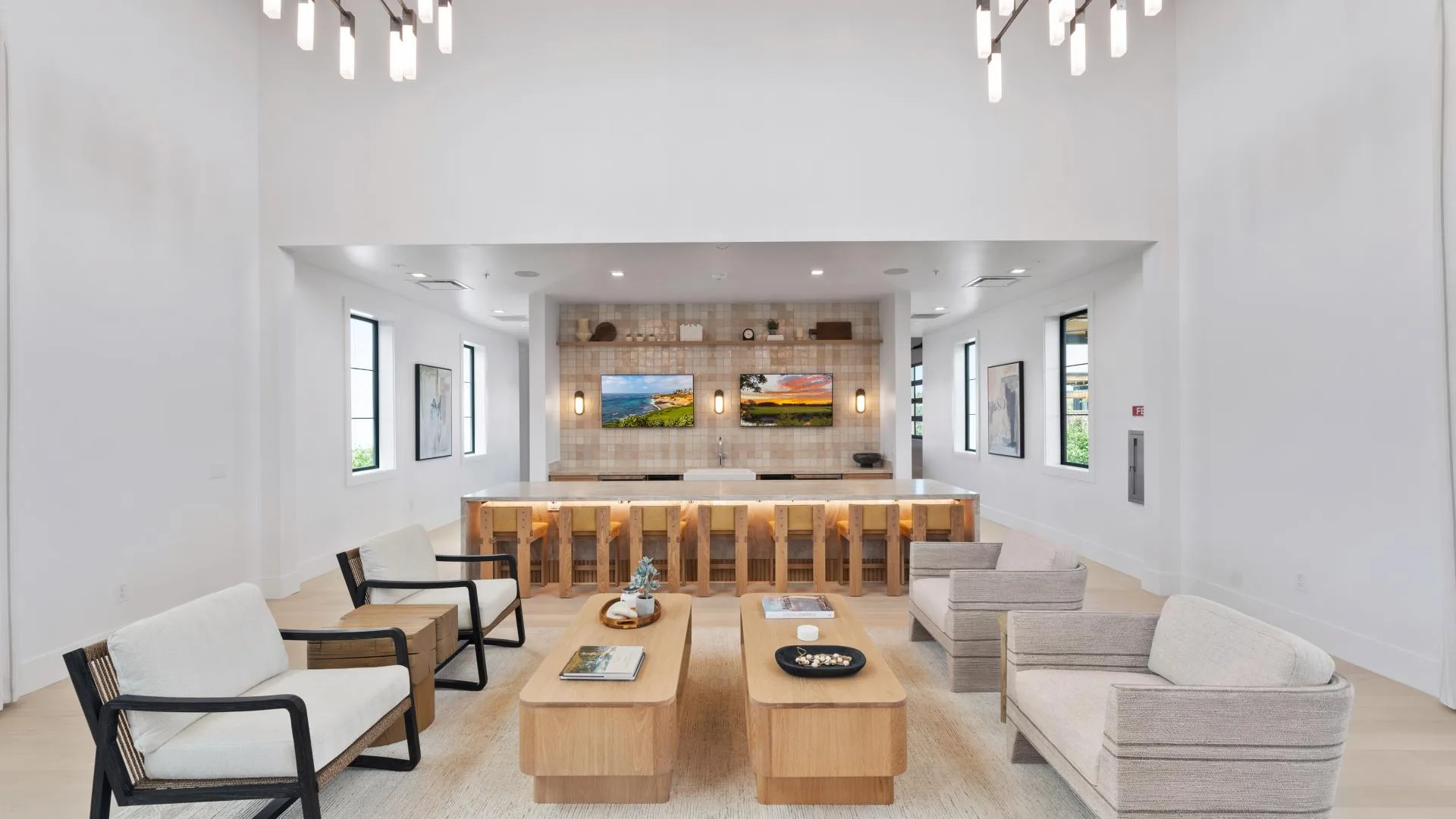 A bright, airy clubhouse lounge with tall windows and comfortable seating in a Northern California 55+ community