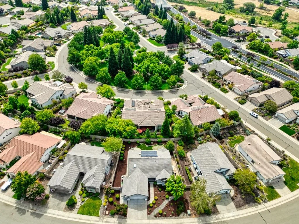 Aerial view of a quiet suburban 55+ neighborhood with single-story homes in Northern California.
