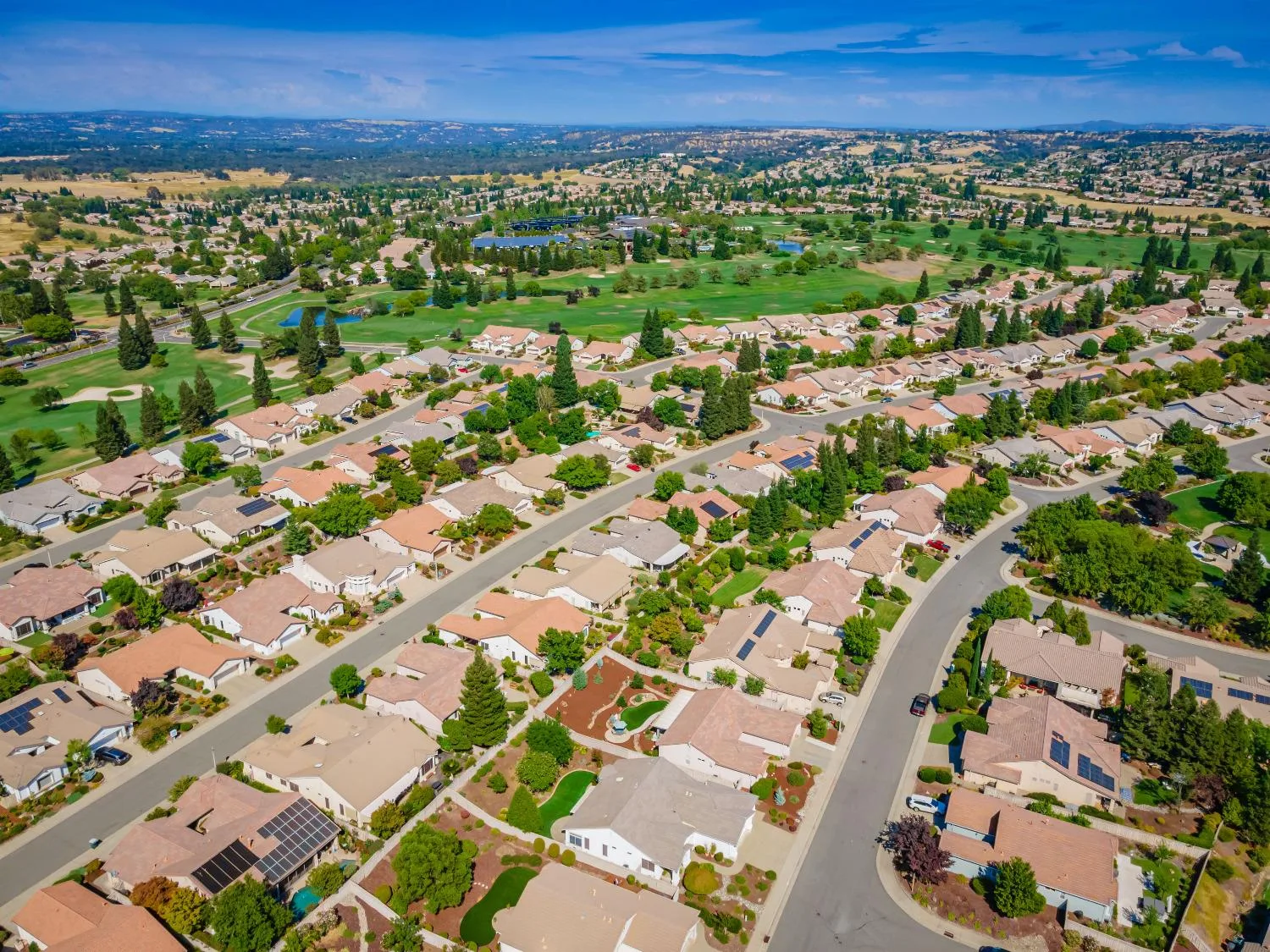 Aerial view of a Folsom foothills neighborhood with single-story 55+ homes and landscaped streets