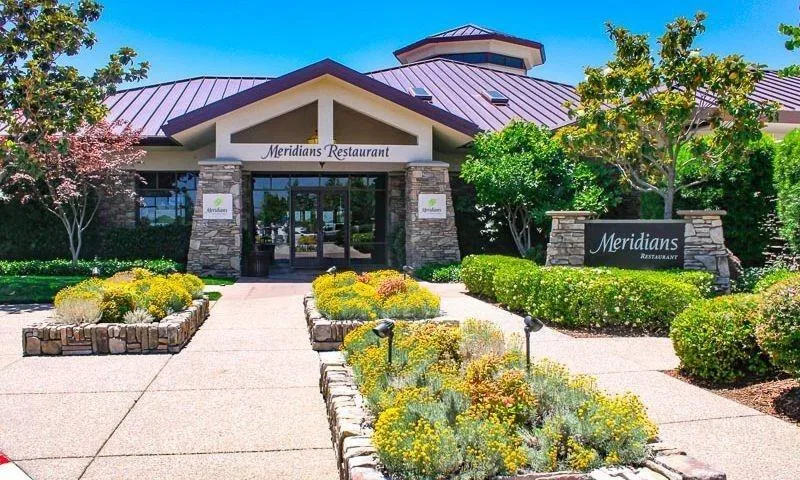 A welcoming restaurant facade with stone masonry and a monument sign in a Northern California town