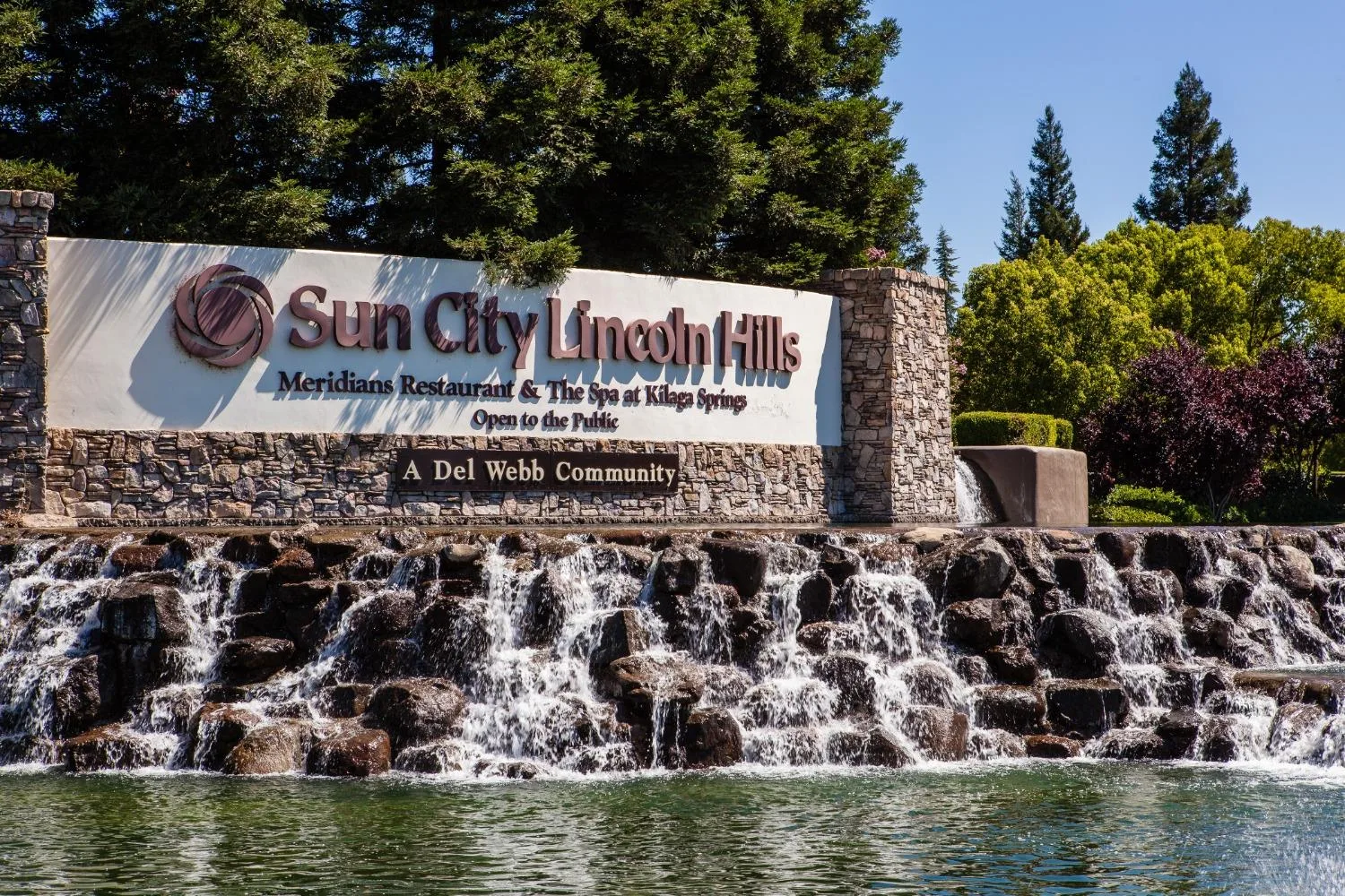 The Sun City Lincoln Hills entrance sign with its waterfall, the landmark welcome to this Del Webb 55+ community in Lincoln, California
