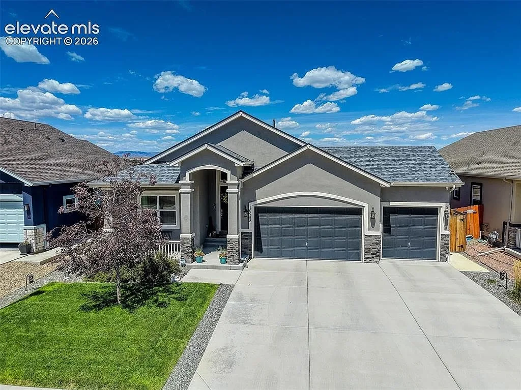 Front facade of 10988 Tarbell Dr, a grey stucco and stone ranch home