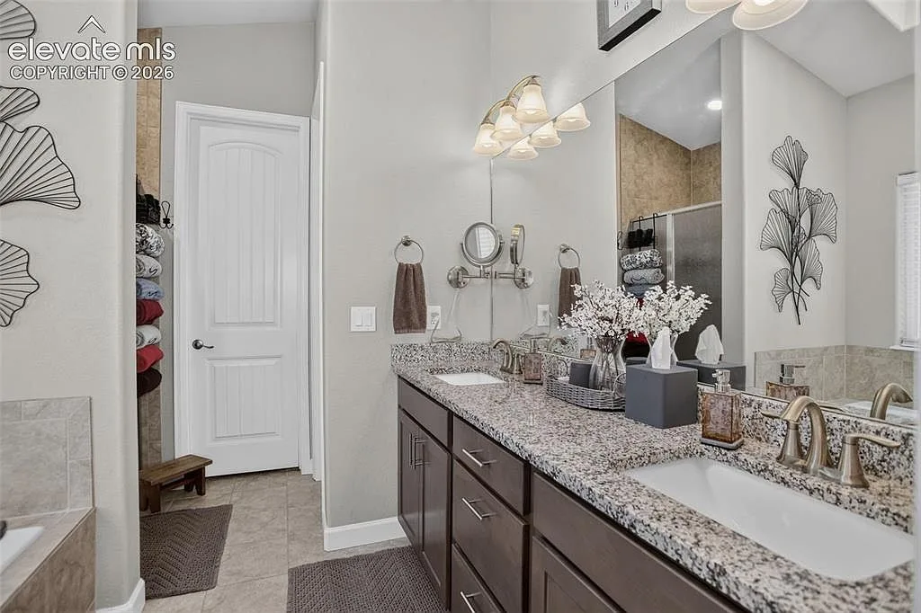 Primary bathroom with dual sinks under a large mirror