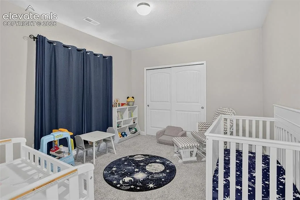 Secondary bedroom with neutral walls and grey carpet