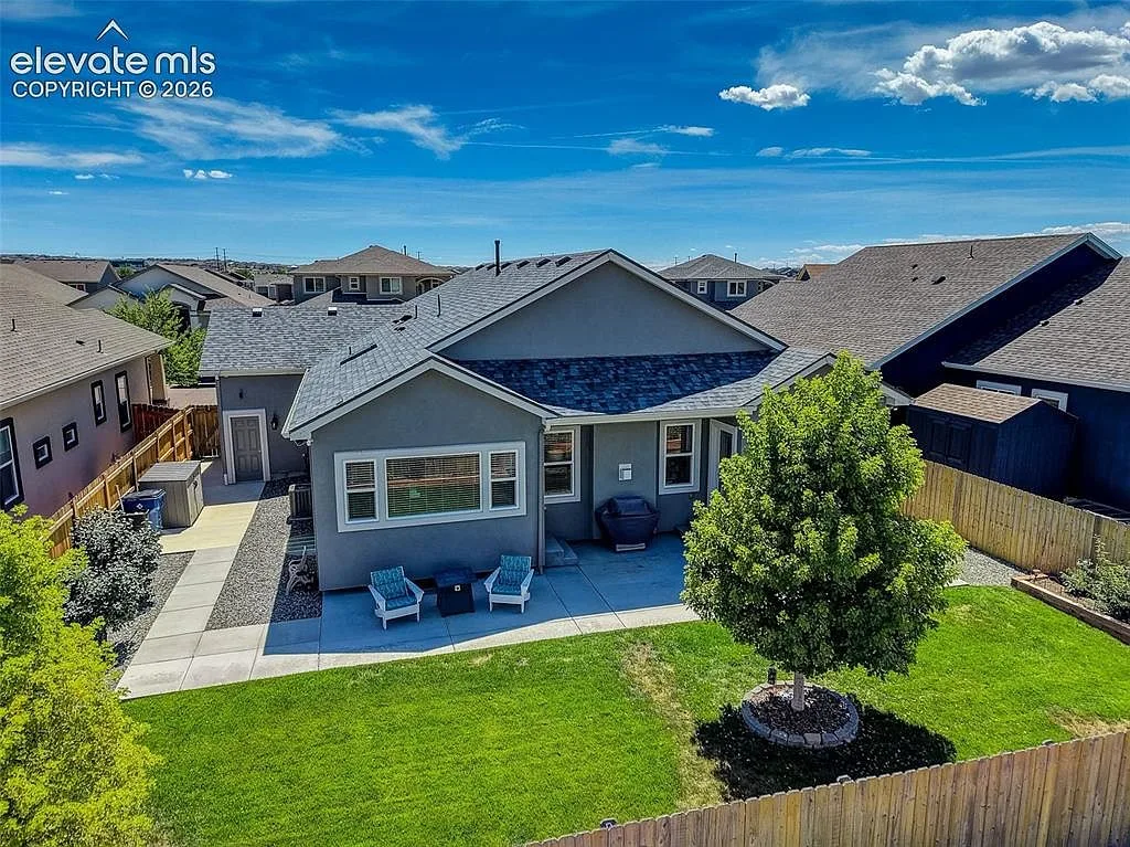 Aerial view of the backyard and rear facade of the home