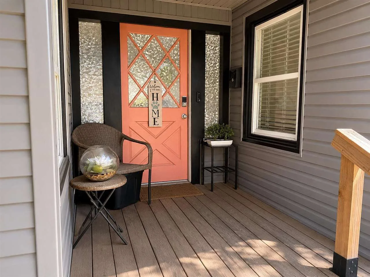 Front porch with coral front door and wood decking