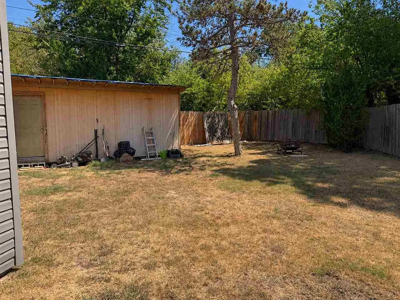 Workshop-style shed behind the home