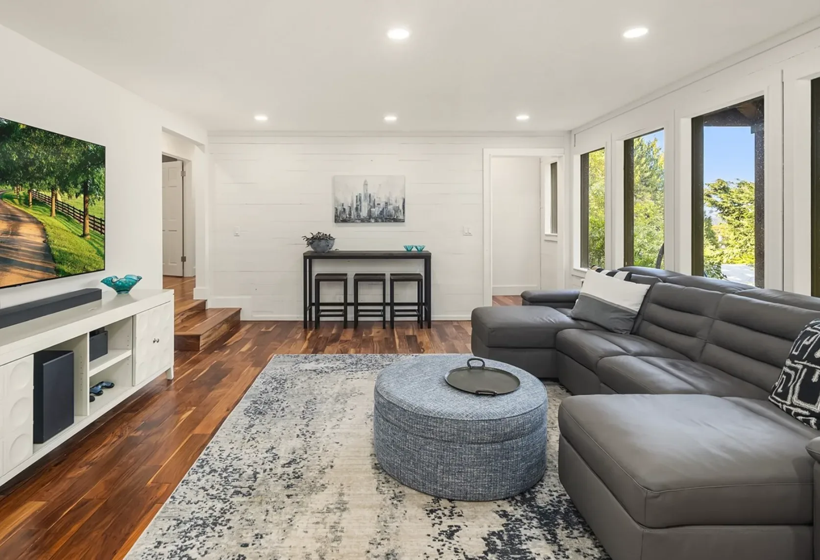 Family room built for movie nights with shiplap walls, built-in furniture space, and room for the whole household