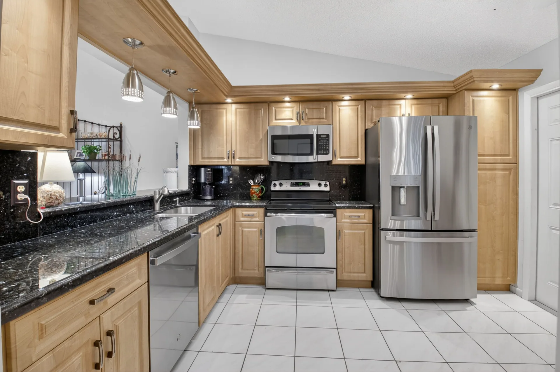 Kitchen with maple cabinetry and stainless steel appliances at 10039 Andrea Lane A