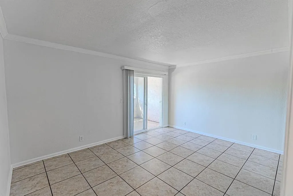Bright living room with sliding glass door at 1085 12th St Unit F