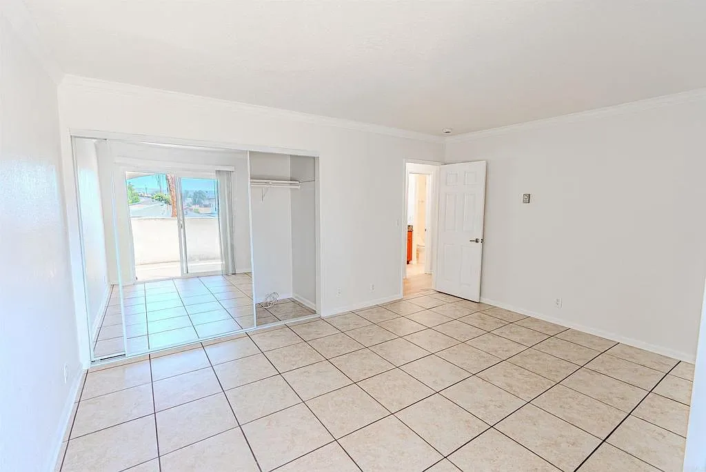 Primary bedroom with sliding closet doors at 1085 12th St Unit F