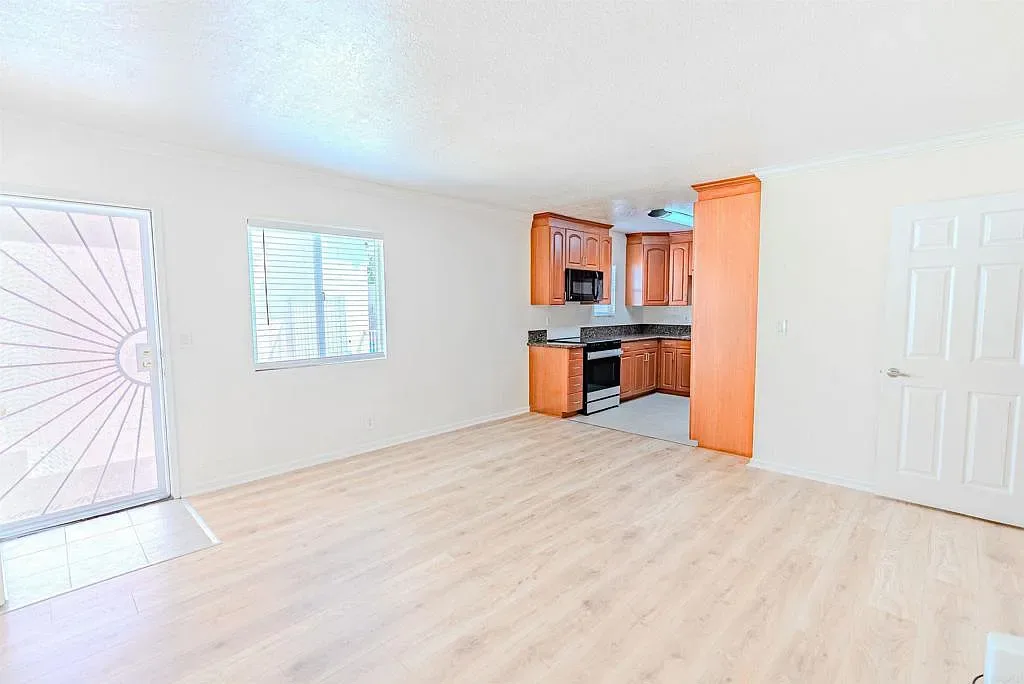Open kitchen and living area with sliding glass door at 1085 12th St Unit F