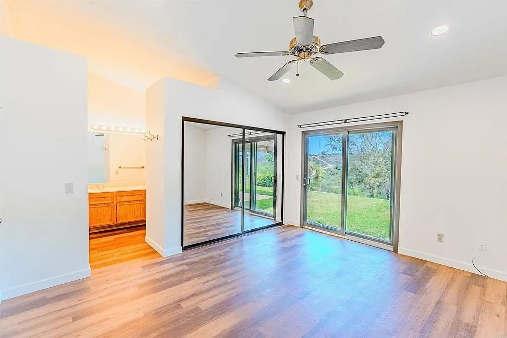 Primary bedroom with en suite access and sliding glass doors at 637 Redlands Pl