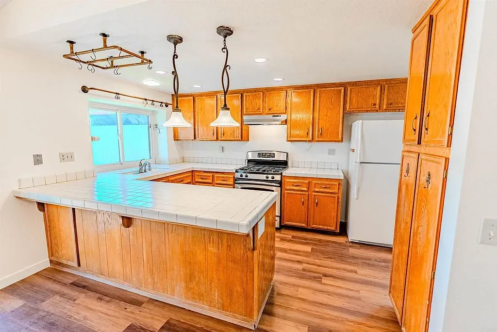 Kitchen with oak cabinetry and pendant lighting at 637 Redlands Pl